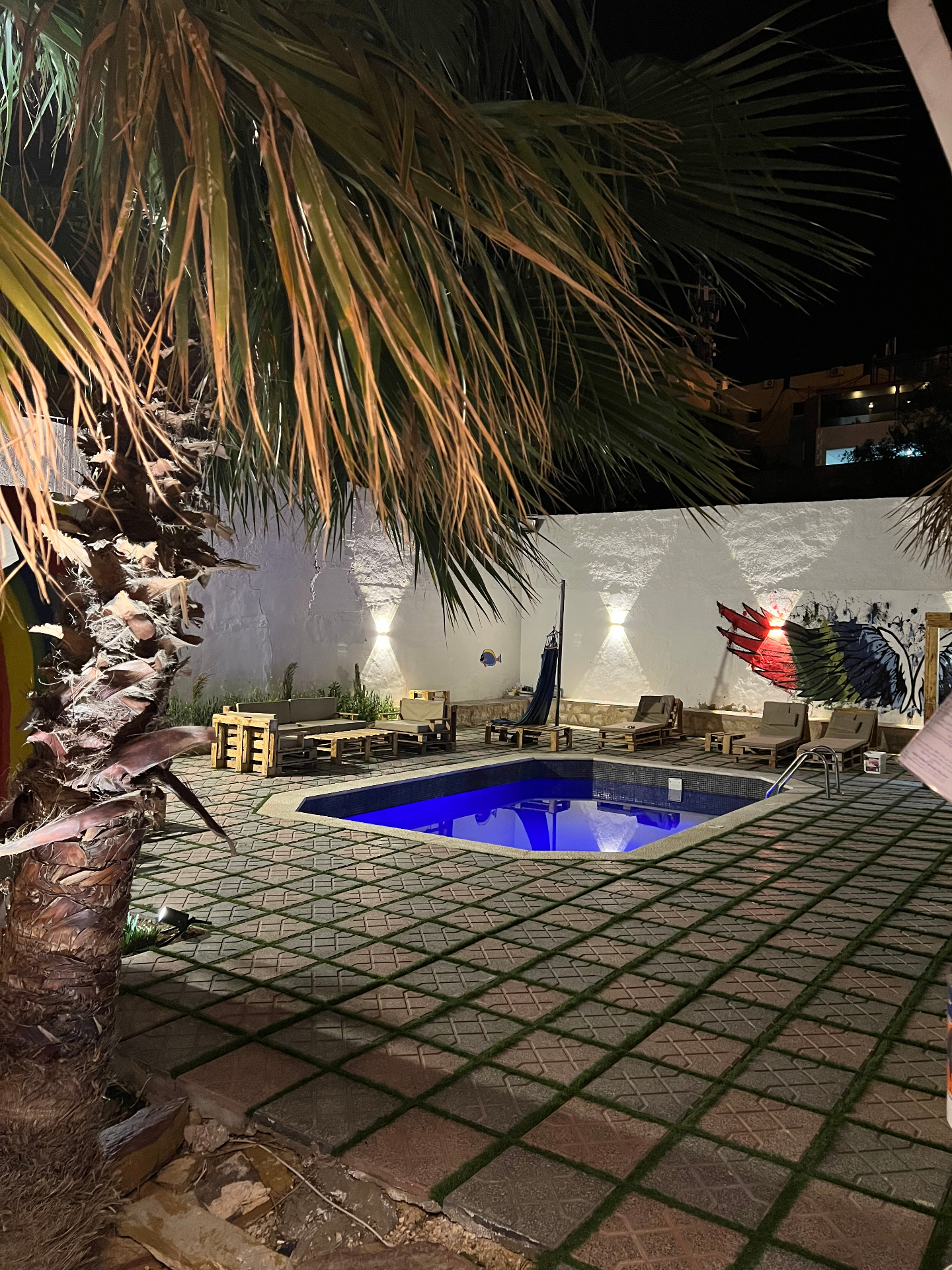 Pool at Rafiki Hostel lit up at night
